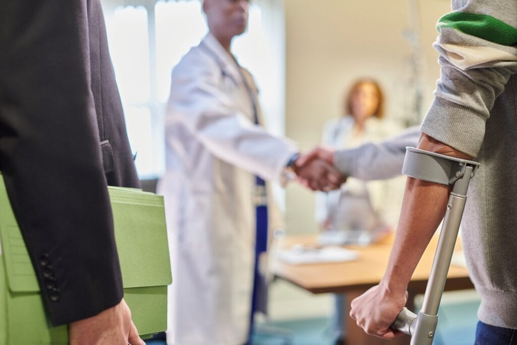 man in hospital with crutches after a delayed car accident injuries