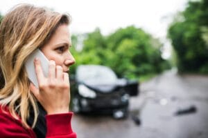 woman on phone after car accident - arizona comparative negligence